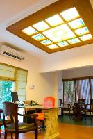 the MD's room with its glass ceiling with a Yantra motif. the table is a sheet of glass supported on two ornamental marble pieces.